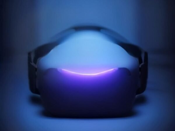 A modern virtual reality headset resting on a dark surface with glowing ambient light.