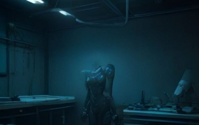 A sleek humanoid robot standing in a modern robotics research laboratory surrounded by high-tech equipment.